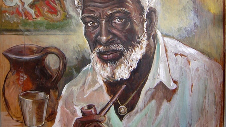 Ilustração de um homem negro, com cabelos, barba e camisa brancos, que segura um cachimbo; no plano de fundo, pode-se ver uma jarra de cor marrom e bege e um copo transparente; a arte parece ser uma pintura a óleo sobre tela. Racismo.