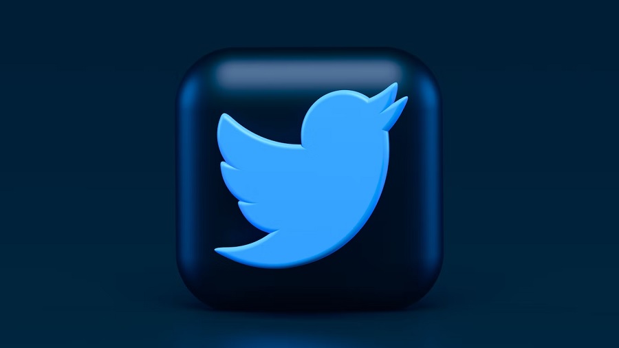 Ilustração mostra um quadrado de cantos arredondados e cor azul-escuro contendo o logo do Twitter, o desenho de um pássaro azul-claro, e um fundo em tom um pouco mais claro que o quadrado. Imagem: Unsplash | Alexander Shatov.